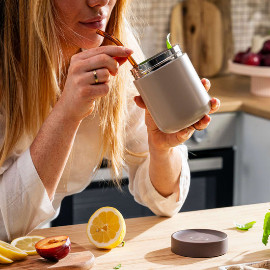 Nommie-snackable-food-jar-sand-in-use-1